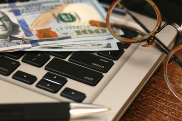 money, dollars, on computer keyboard