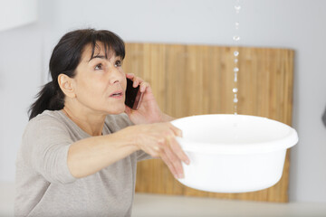 woman calling to plumber for water leakage problem