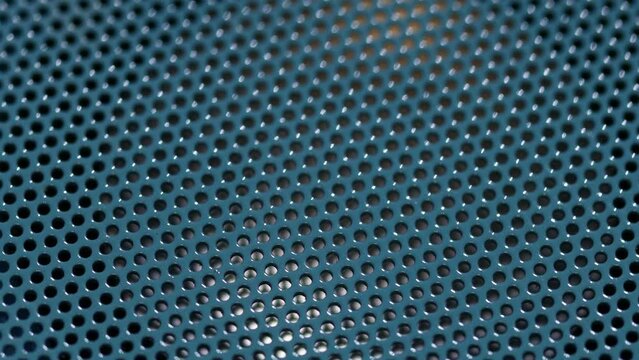 acoustic speaker with blue grille rotates in a circle