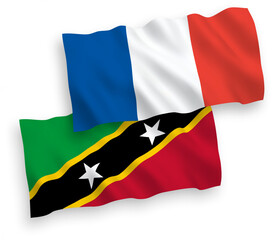Fototapeta premium National vector fabric wave flags of France and Federation of Saint Christopher and Nevis isolated on white background. 1 to 2 proportion.