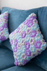 Crocheted handmade pillowcases with light blue, violet and grey flower pattern in interior