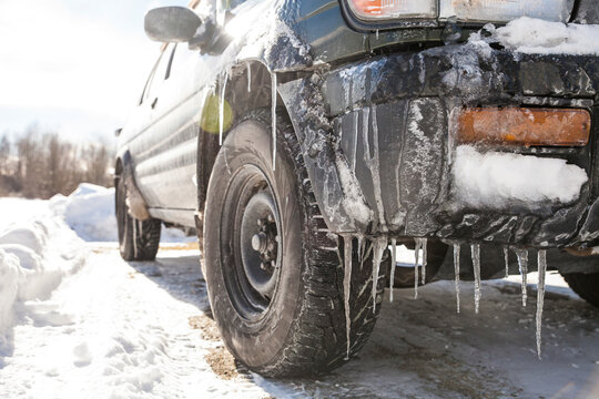 Close-up of frozen car on road during winter