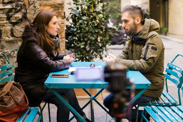 woman is interviewing a man with beard