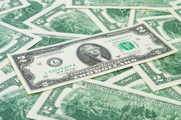 U.S. dollars banknotes of the united States of America. Background of many american dollar banknotes. Two dollars.