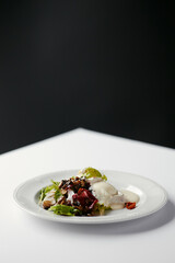salad with herbs, mushrooms and poached egg