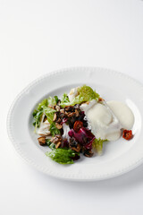salad with herbs, mushrooms and poached egg