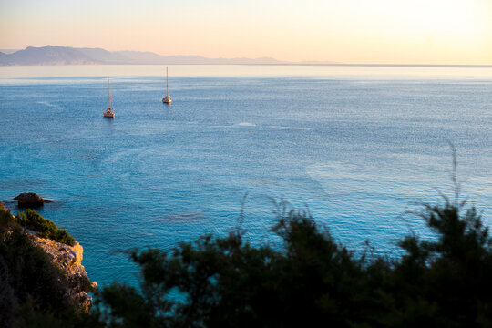 Sailboats at sunrise in Cala Goloritz&Atilde;&uml;. Sardinia, Italy.