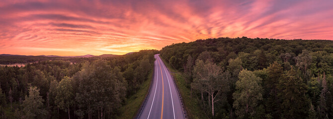 Route 9 road through forest at sunrise, Woodford, Vermont, USA