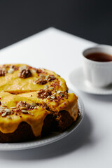 pumpkin pie with icing, decorated with nuts