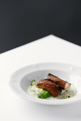 eel baked and laid on avocado