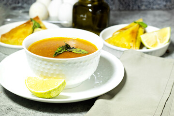 traditional bowl of spiced algerian vegetable soup named (Harira) and meat bourak named bourek and eggs