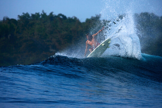 A surfer lands an aerial move at G-Land, Java, Indonesia.