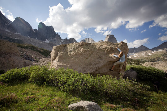 A female rock climber boulders in the Cirque of the Towers, Wind River Range, Wyoming.