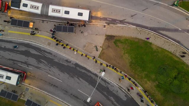 passengers in the queue for boarding the bus on a busy street at the end of the day, time lapse. High quality 4k footage