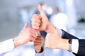 Happy business team showing thumbs up in  office