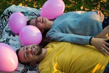 happy couple in the park with balloons