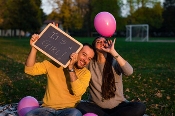 couple celebrates the birth of the baby in the park