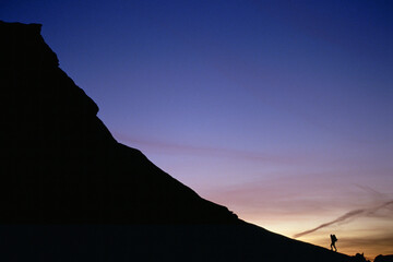 A lone hiker at sunset, Canyonlands National Park, Utah.