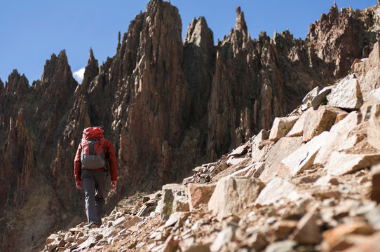 Man hiking above Yankee Boy Basin to climb Mount Sneffels in San Juan Mountains, Telluride, Colorado, USA