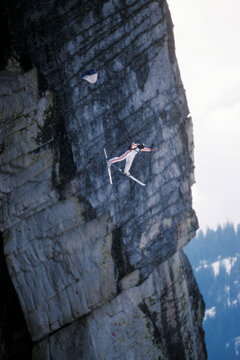 Ski-BASE jumper doing a front flip off a cliff near Lake Tahoe.