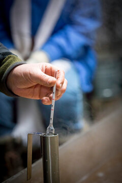 Hand of man using hydrometer,&acirc;&euro;&nbsp;Little&acirc;&euro;&nbsp;Suamico, Wisconsin, USA