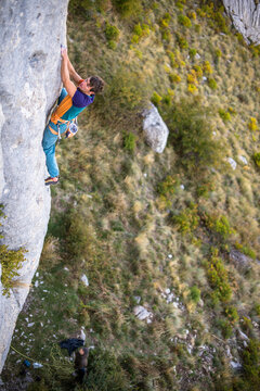 Men climbing a sport route on limestone in Ceuse, France.
