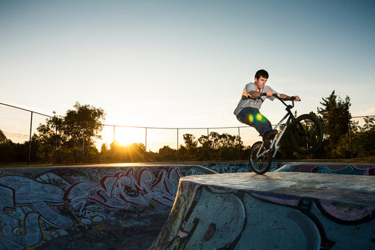 BMX biker rides in a skate park.