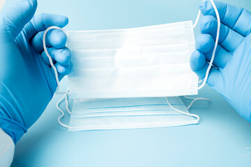 Medical protective mask on a blue background, coronavirus prevention, virus protection factor. Medical or surgical face mask. Virus protection. Respiratory respiratory mask.