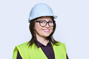 Female industrial construction worker in hardhat vest on white background