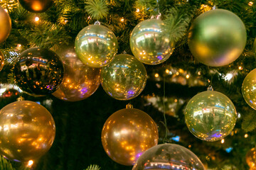 Many different Christmas balls on the Christmas tree. Close-up. Festive Christmas toys. Christmas decorations.