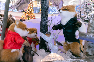 Toy foxes play musical instruments. An orchestra of toy animals against the backdrop of an...
