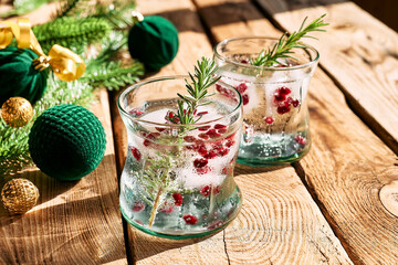 Christmas champagne cocktail with pomegranate ice cubes. Festive pomegranate mocktail. Delicious...