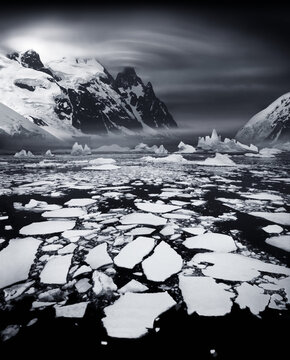 Ice shoals near the Antarctic Circle with lenticularis cloud over mountain peak. Usually this area is frozen.