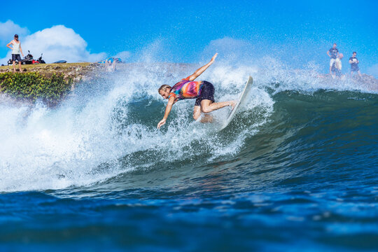 Surfer riding wave in sea, Jimbaran, Bali, Indonesia
