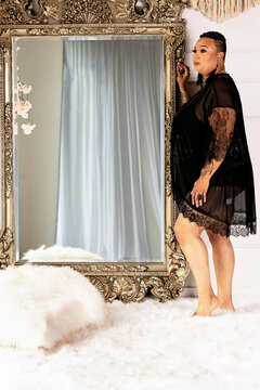 Plus size Black Woman standing in front of mirror in lingerie
