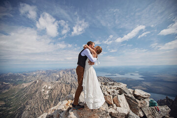 just married couple shares first kiss on summit of Grand Teton Wyoming
