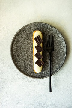French dessert eclair on the plate