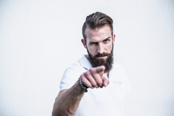 Portrait of a young man pointing in front of wall, Bavaria, Germany