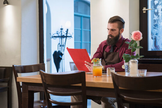 Owner reading menu at restaurant
