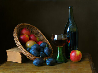 Still-life with fruit and wine against a dark background