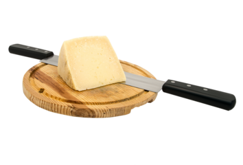 Piece of cheese next to a knife on a wooden board.
