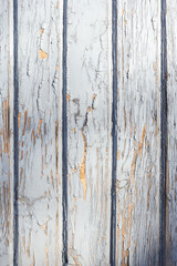 Fototapeta na wymiar Light blue weathered wooden background with cracked paint