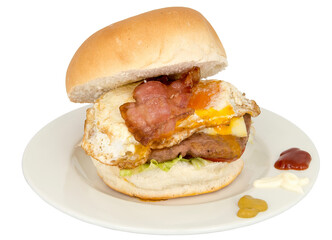 Burger with bacon and eggs on a plate isolated.