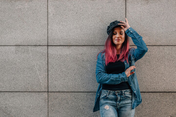 urban hipster woman on street wall