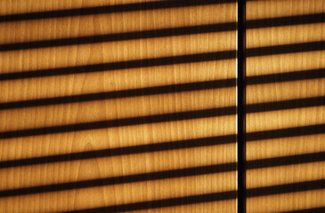 blinds shadow on wooden wall background