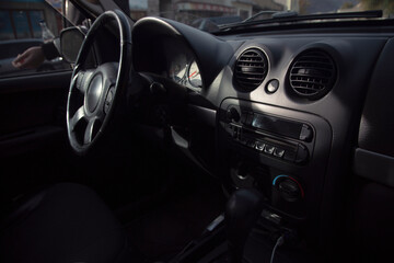Fototapeta na wymiar Black steering wheel in luxury car