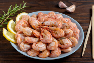 shrimp boiled in a plate on a wooden background