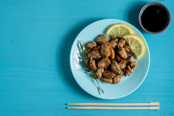 mussels with noodles boiled in a plate with spices on a blue background