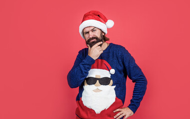 party goer. merry christmas. cheerful bearded man in santa claus hat and sweater. brutal hipster celebrate xmas party. winter holiday preparations. present and gift shopping sale. happy new year