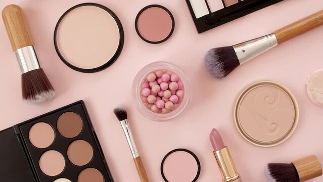 A set of decorative cosmetics on pink background. Makeup products. The beauty of the background with cosmetic facilities. Makeup, the concept of skin care with. High quality 4k footage. 4k